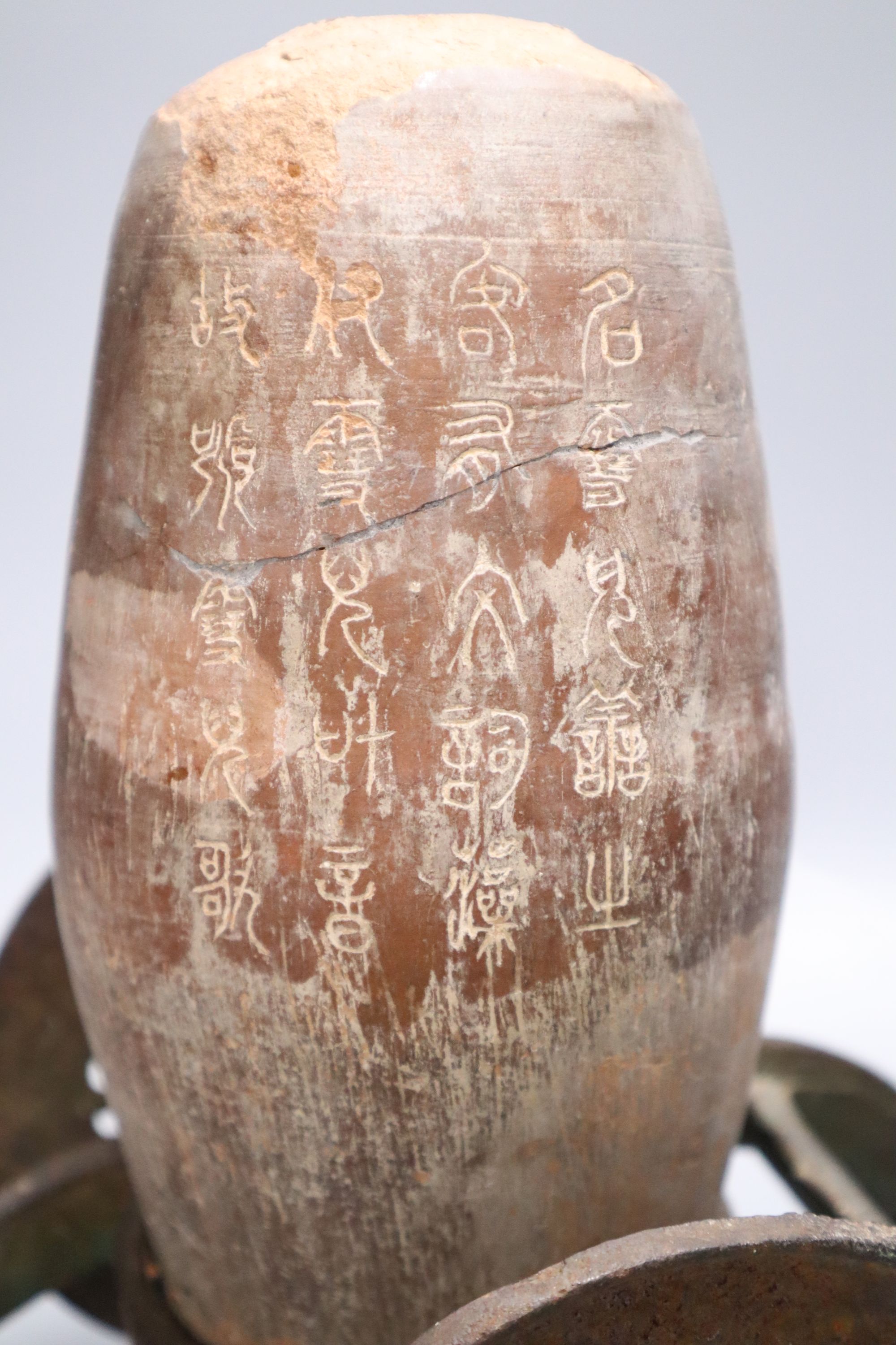 A Chinese pottery vase, with an iron carriage base, Han dynasty or later, height overall 28cm